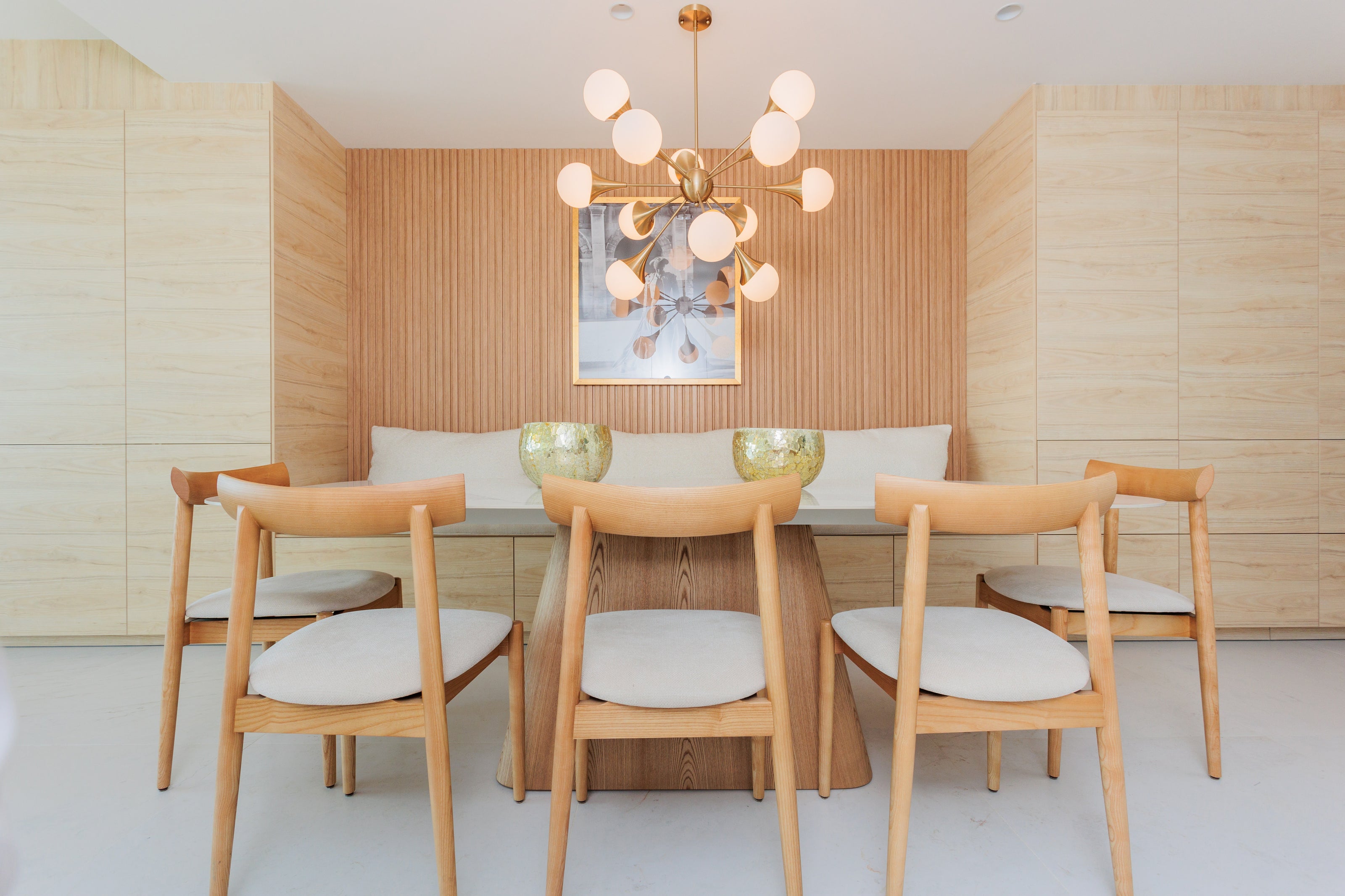 luxury interior design for dining room with wooden dining table, wooden dining chairs, decors, stylish ceiling lamp available in marbella, malaga, estepona, elviria, the estrella del mar real estate interior design.