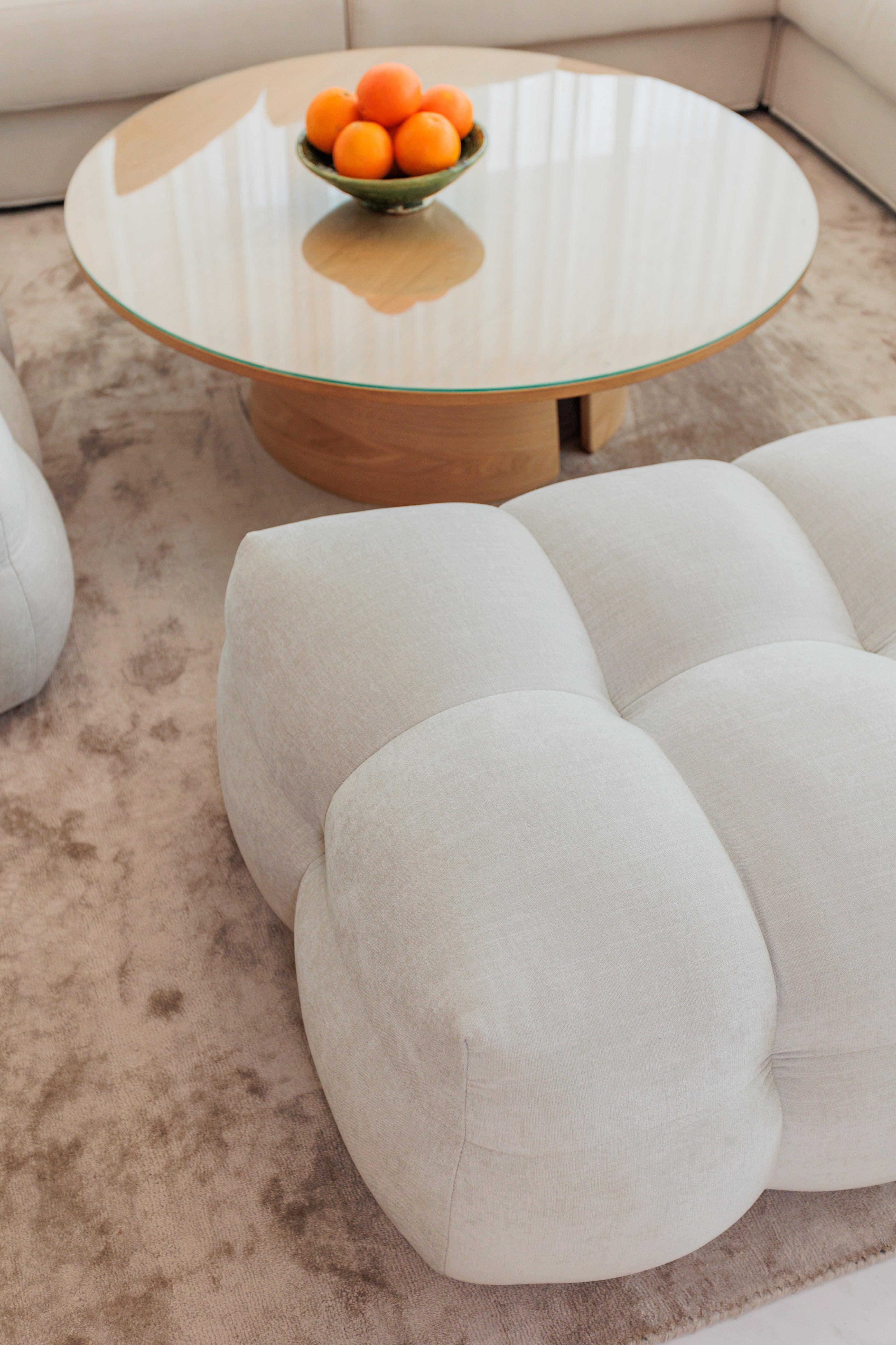 indoor interior design, living room, modern minimalist coffee table, rug, round edge soft pouf available in cancelada, marbella, benahavis, malaga, costa del sol, estepona.