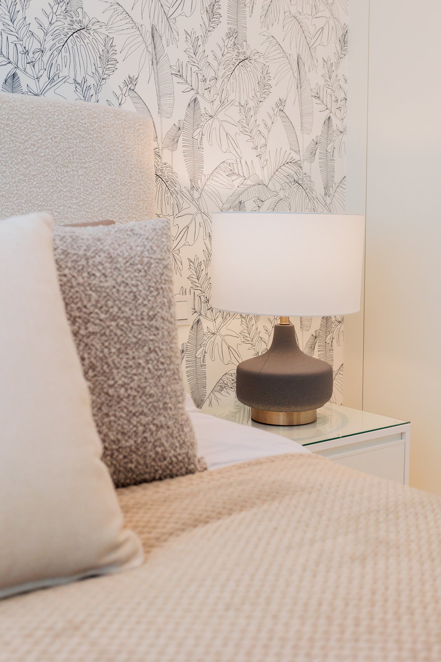 modern cream brown interior design for bedroom with brown and gold lamp and clean black and white wallpaper available in bel air, marbella, malaga, costa del sol.