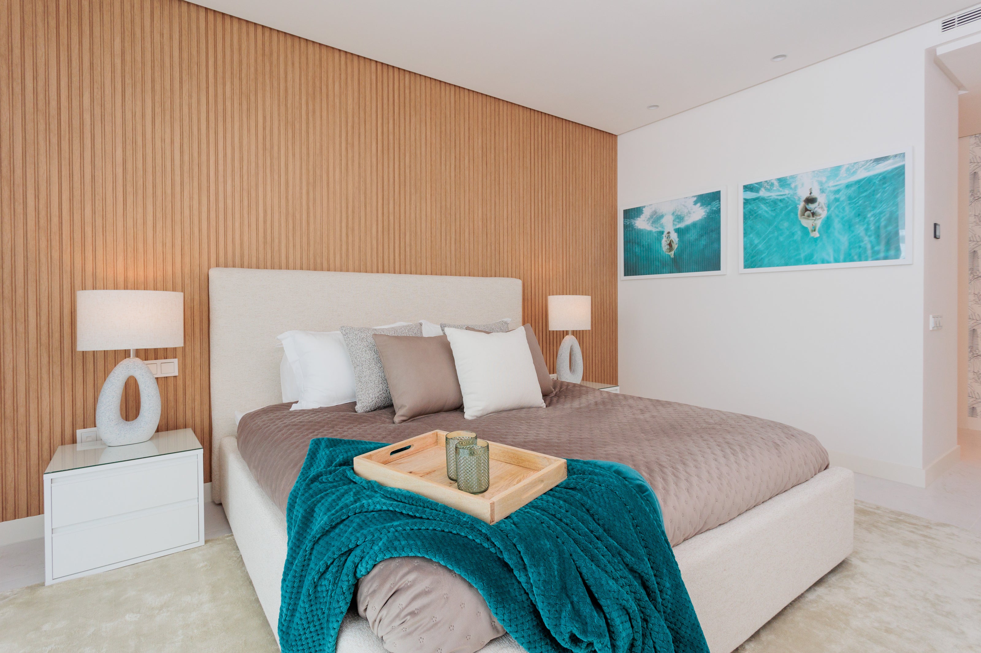 luxury elegant bedroom interior design with bed, headboard, bedroom table, table lamp, artworks green blue, rug available in alcazaba, marbella, malaga, estepona, costa del sol.
