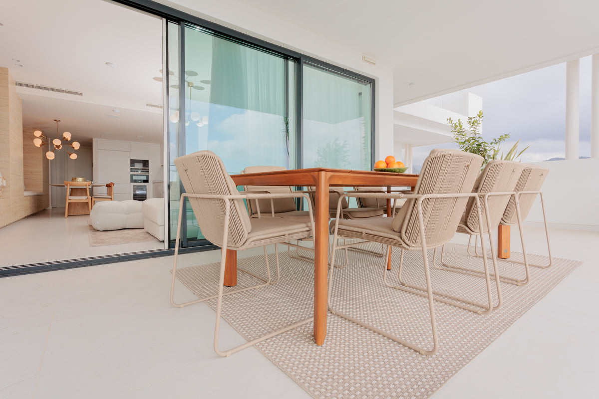 modern outdoor dining interior design, with wooden dining table, aluminium outdoor dining chairs, outdoor rug available in benalmadena, marbella, malaga, costa del sol, bel air.
