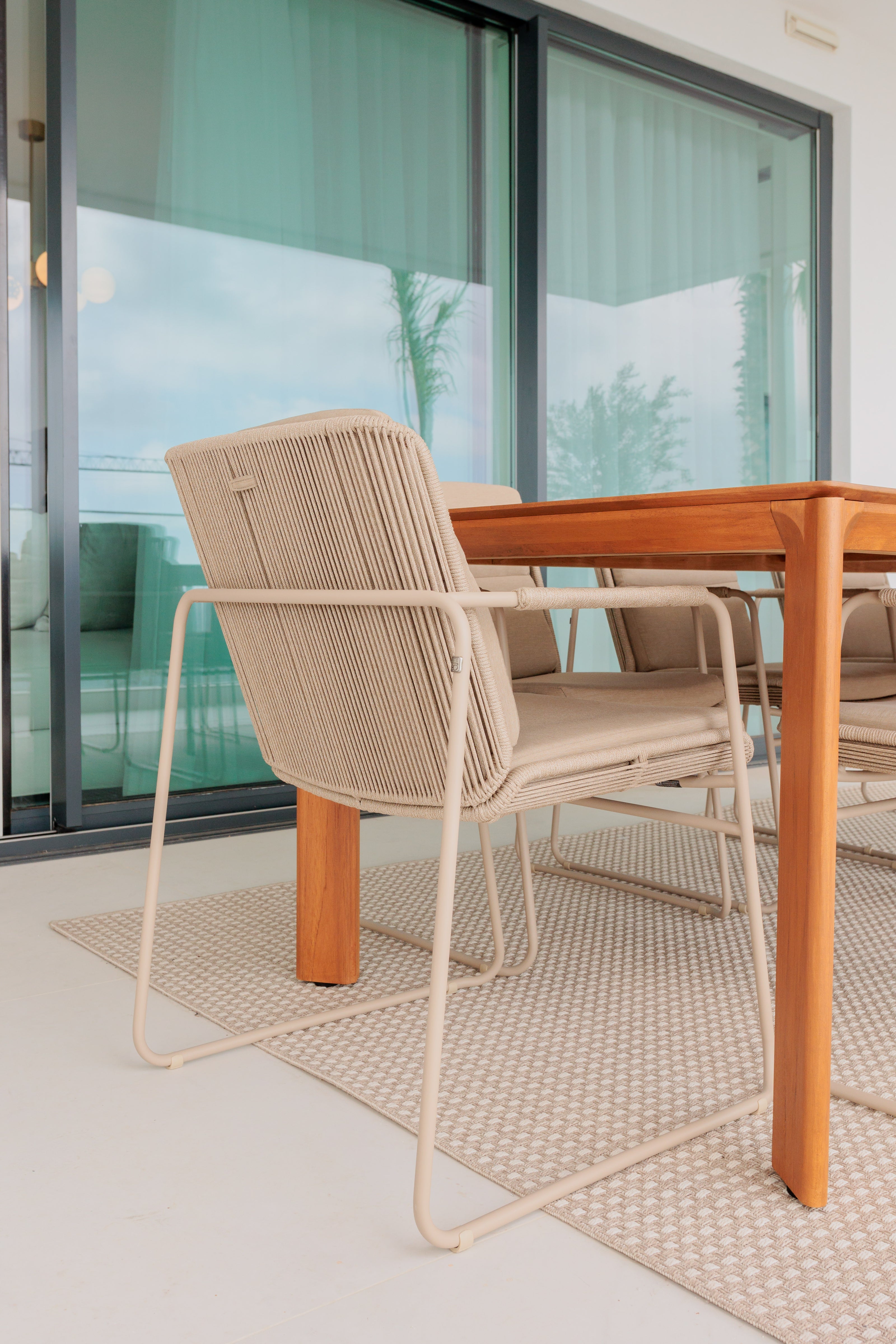 luxury interior design for outdoor furniture with wooden dining table, aluminium beige outdoor chair and beige outdoor rug available in benalmadena, marbella, malaga, costa del sol.