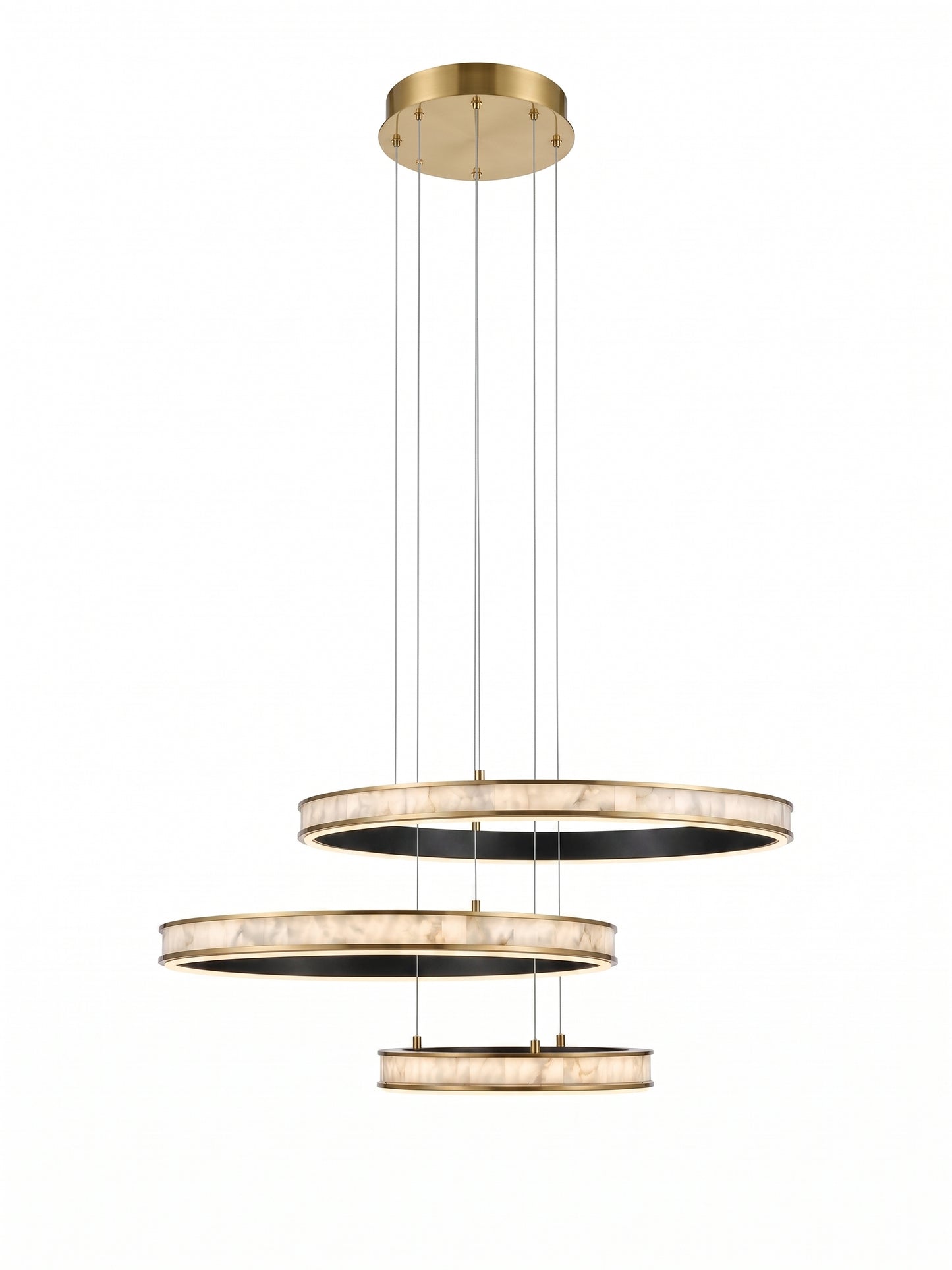 A modern three-tier circular pendant chandelier with a brushed gold finish and textured white marble-like rings, suspended by thin cables against a solid white background.