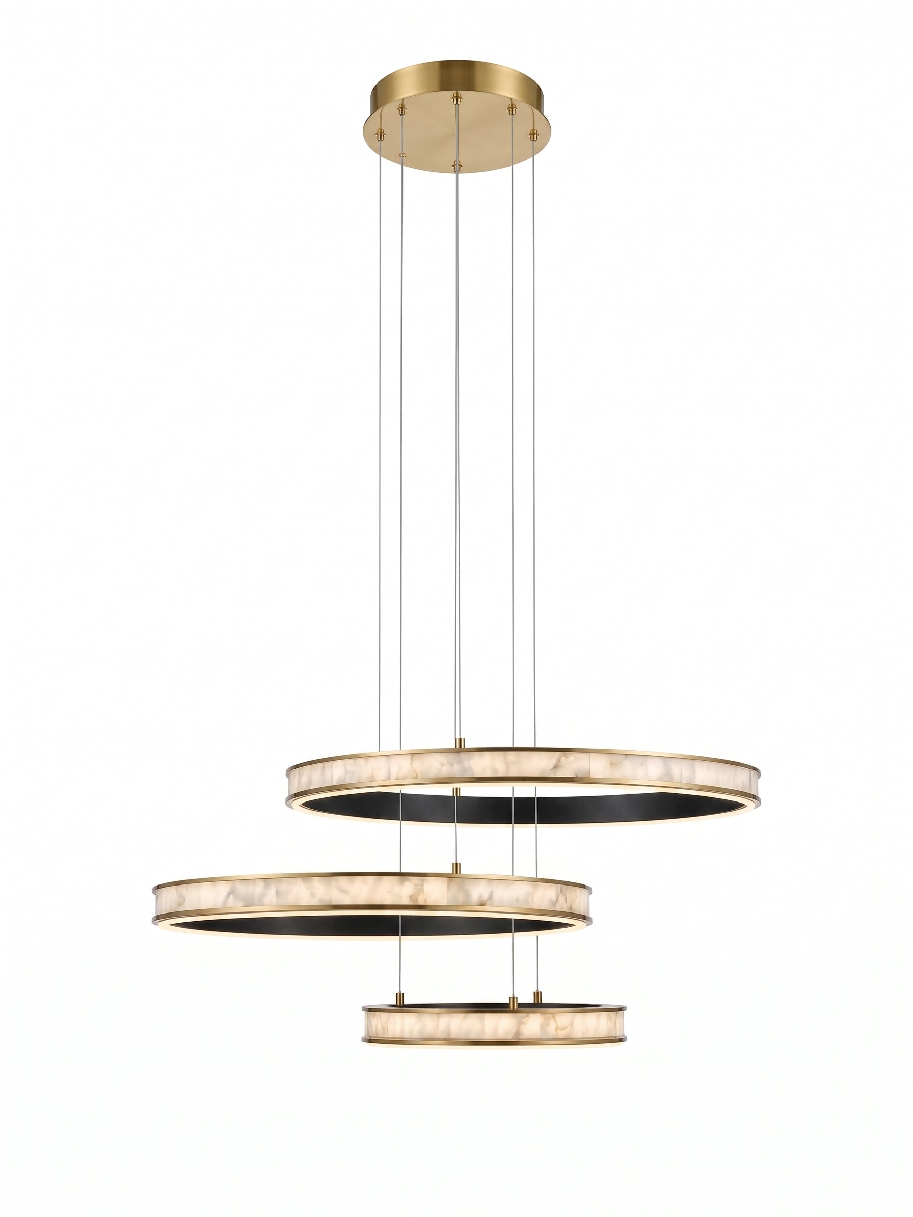 A modern three-tier circular pendant chandelier with a brushed gold finish and textured white marble-like rings, suspended by thin cables against a solid white background.