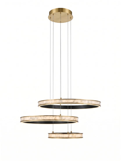 A modern three-tier circular pendant chandelier with a brushed gold finish and textured white marble-like rings, suspended by thin cables against a solid white background.