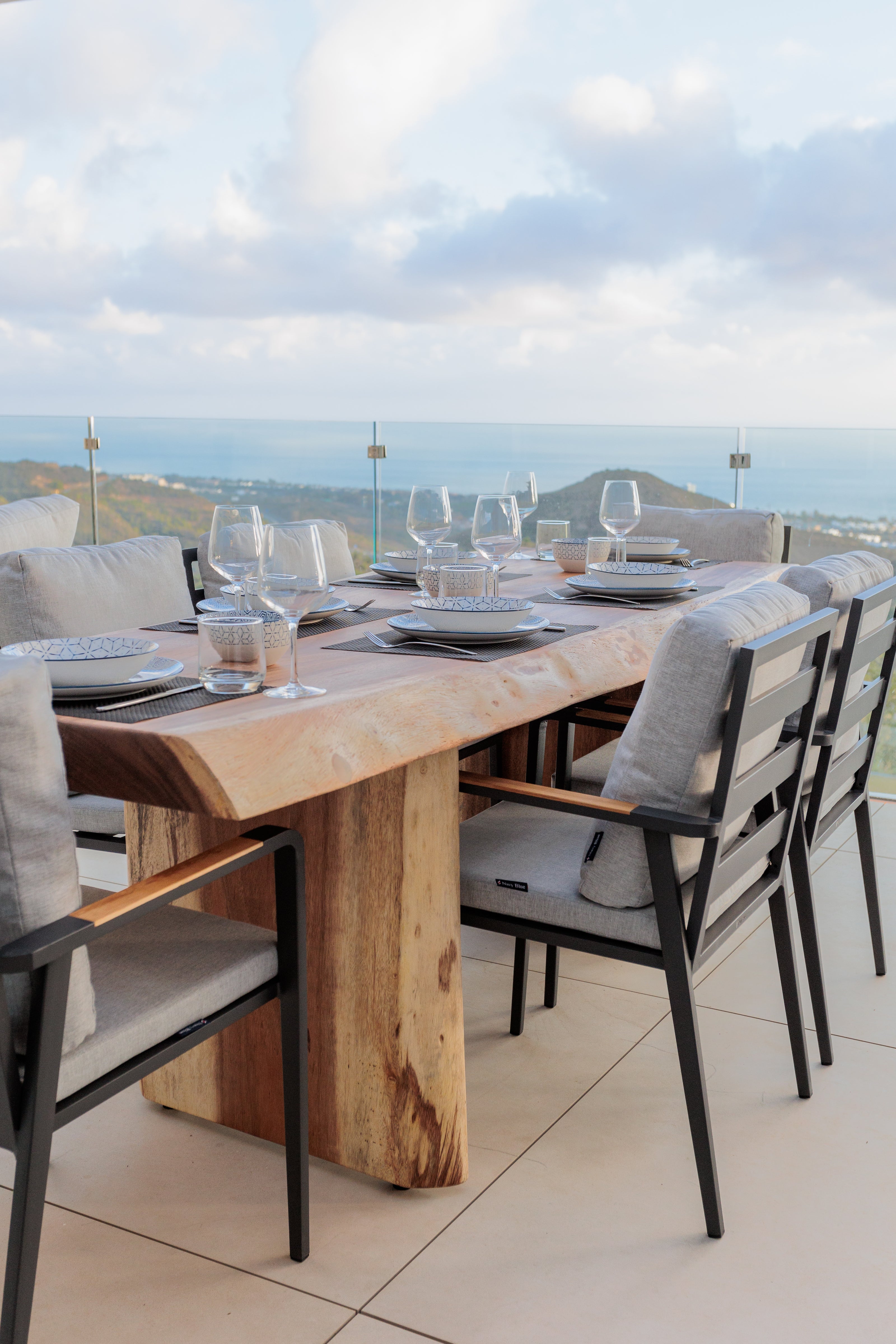 luxury interior design for outdoor furniture with wooden outdoor dining table, aluminium dining chair, glassware on the table available in costa del sol, marbella, malaga.